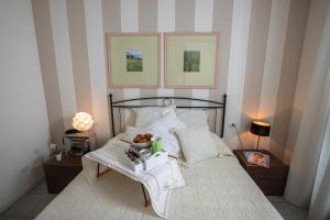a bedroom with a bed with a tray of food on it at Chianti Village Morrocco in Tavarnelle in Val di Pesa