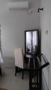 a desk with a mirror and a chair and a table at Albert Guest - Galle Fort in Galle