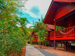 Ban Tai Resort في بان تاي: مبنى بطابق احمر بجانب شارع