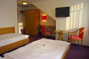 Postel nebo postele na pokoji v ubytování Hotel Park Eckersbach