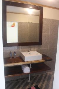 a bathroom with a sink and a mirror at Village Corner Homestay in Kuta Lombok