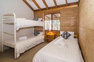 
A bunk bed or bunk beds in a room at Woodstone Grass Tree Cottage
