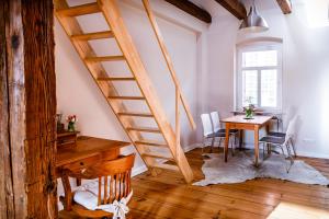a staircase in a room with a table and chairs at Hotel Anna in Stendal