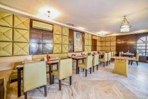 a restaurant with wooden walls and tables and chairs at Hotel Sugan Niwas Palace in Jaipur