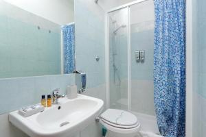 a bathroom with a sink and a toilet and a shower at Domus Domas - Golden Keys Collection in Rome