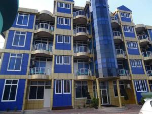 a large blue and yellow building with balconies at BL Airport Hotel in Dar es Salaam