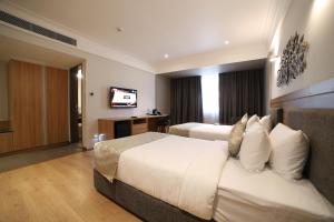 Ein Bett oder Betten in einem Zimmer der Unterkunft Native INN By Heda Hospitality