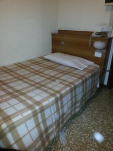 Postel nebo postele na pokoji v ubytování Hotel Lombardia