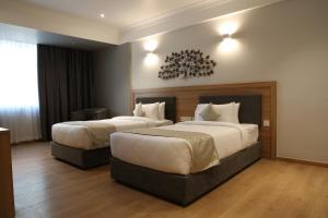 Ein Bett oder Betten in einem Zimmer der Unterkunft Native INN By Heda Hospitality