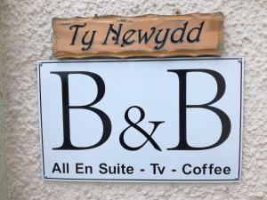 Un cartel que dice televisión revisada y todo el café de la suite en Ty Newydd, en Llangadog