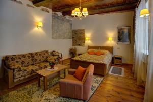 a living room with a bed and a couch at Bernardinu B&B House in Vilnius