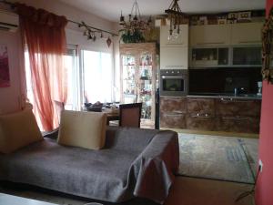 a living room with a couch and a kitchen at Apartment with Amazing View & parking in Kavála