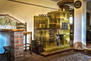 a room with a large gold stove in a room at Gajowe Zacisze in Mirsk