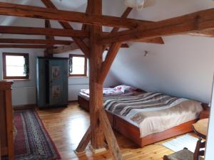a bedroom with two beds in a room with wooden beams at Gajowe Zacisze in Mirsk