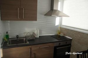 a kitchen with a sink and a counter top at Puerto Marina waterfront apartment in Benalmádena