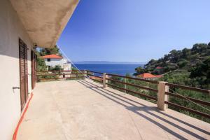 a balcony of a house with a view of the ocean at Robinson Torac in Gdinj