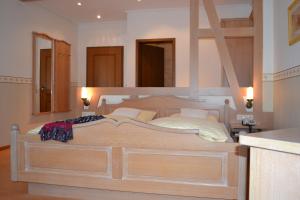 a bedroom with a large wooden bed with two mirrors at Hotel Gasthof Rödertor in Rothenburg ob der Tauber