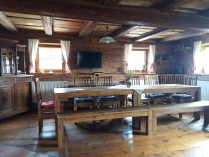 a large dining room with wooden tables and chairs at Gajowe Zacisze in Mirsk