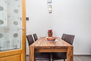 a wooden table with chairs and a bowl of flowers on it at Agriturismo La Selvaggia in Mandello del Lario