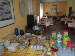 a table with a bunch of food on it at Hotel Conchiglia in Montecatini Terme