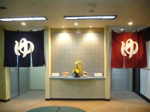 a display case with the chinese symbol on the wall at Aokiya in Sado