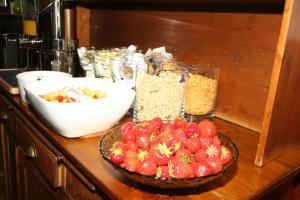 a counter with a bowl of strawberries and other ingredients at Hotel Albion in Scheveningen
