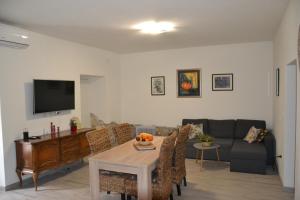 a living room with a table and a couch at Faveria Apartments Amphitheater with FREE Parking in Pula
