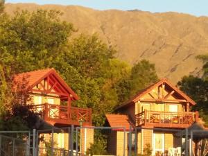 a couple of houses in front of a mountain at Cabañas Dalga Inn in Merlo