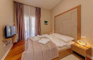 Postel nebo postele na pokoji v ubytování Hotel Tre Canne