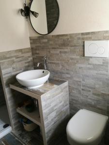 a bathroom with a sink and a toilet and a mirror at Kikka's House in La Spezia +6 photos