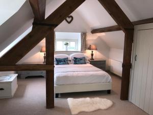 a bedroom with a bed in a attic at Cornerstone Cottage in Chipping Campden