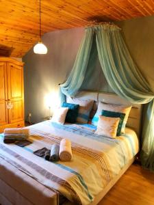 a bedroom with a large bed with a canopy at B&B Bourgeoisie*** in Frahan