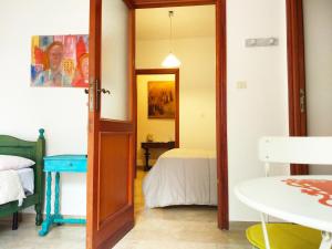 a room with a door leading to a bedroom at Amariglio Apartment in Sassari