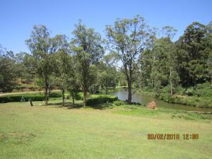 a body of water with trees and a river at Tree House Holiday Home in Bandarawela