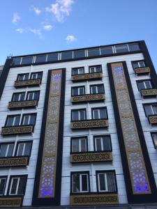 a tall white building with stained glass windows at Grand Kayalar Hotel in Antalya