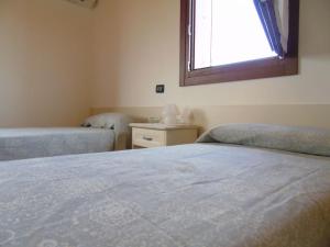 A bed or beds in a room at B&B Ai Cipressi