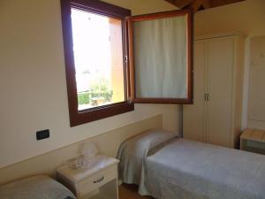 A bed or beds in a room at B&B Ai Cipressi