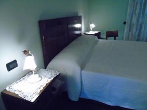 A bed or beds in a room at B&B Ai Cipressi