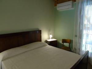 A bed or beds in a room at B&B Ai Cipressi
