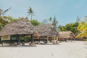 a group of huts on the beach at Mikadi Beach Camp & Backpackers in Dar es Salaam