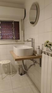 a bathroom with a sink and a mirror at Terrazze Fiorite in Bergamo