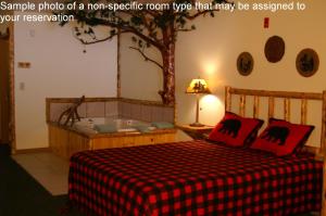 a bedroom with a bed with a tree on the wall at Meadowbrook Resort in Wisconsin Dells