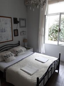 a bedroom with a bed with white sheets and a window at House Grabic in Tivat