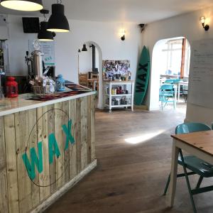 a restaurant with a counter with a sign on it at Wax, Watergate in Newquay