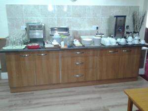 a kitchen with a counter with dishes on it at The Trentham Hotel in Blackpool