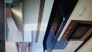 a view of a kitchen with a counter and cabinets at Apartamento la romanilla a 200metros de la playa in Roquetas de Mar +2 photos