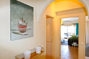 a hallway with a painting on the wall at Marbel Sol - Clever Details in Vilamoura