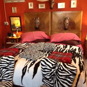 a bedroom with a large bed with zebra pillows at Al Porretto in Madonna della Provvidenza