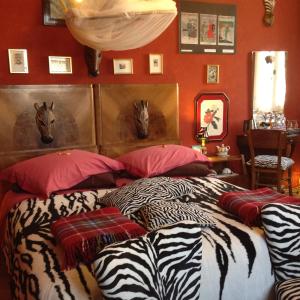 a bedroom with a bed with zebra pillows at Al Porretto in Madonna della Provvidenza