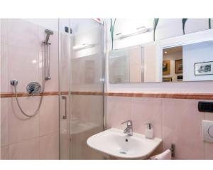 a bathroom with a sink and a shower with a mirror at Luna sui tetti in Santa Margherita Ligure